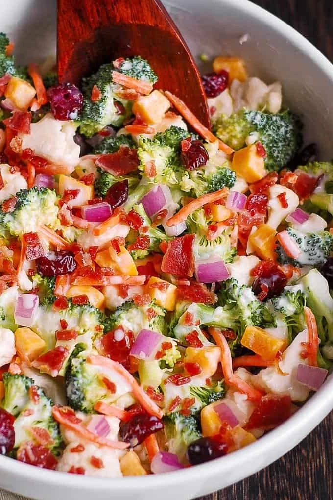 Creamy Broccoli and Cauliflower Salad with Cheddar Cheese, Bacon, Cranberries, Carrots, Red Onions, and homemade salad dressing. finished