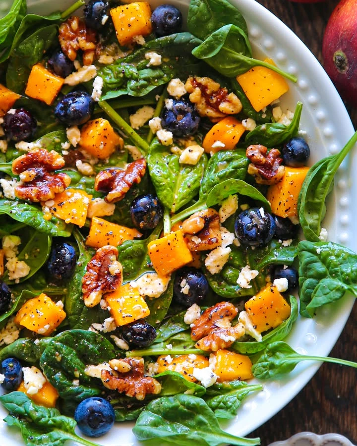 Mango and Blueberry Spinach Salad with Walnuts, Feta Cheese, and Lemon Honey Mustard Dressing finished
