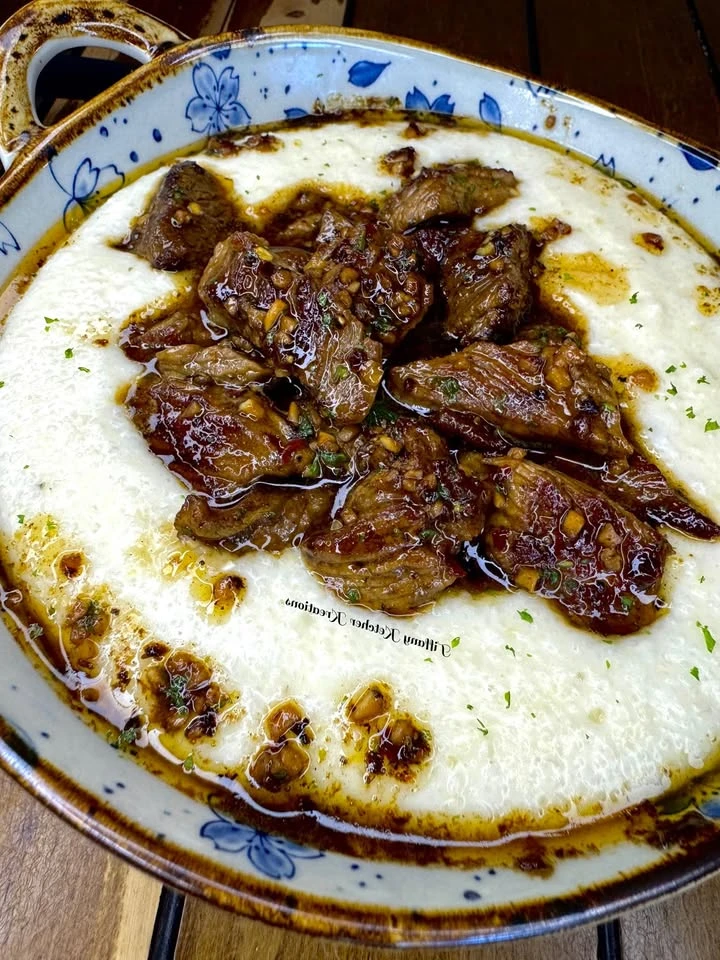 Steak bites over creamy smoked Gouda grits finished