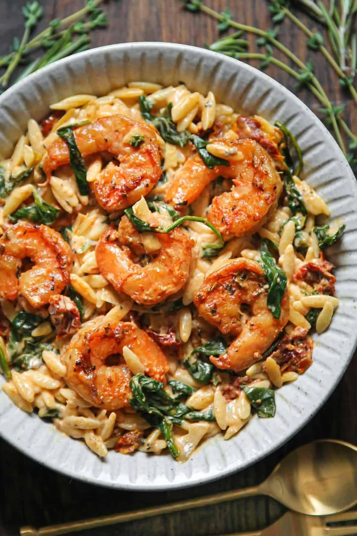 Tuscan Shrimp Orzo with Spinach, Artichokes, and Sun-Dried Tomatoes finished